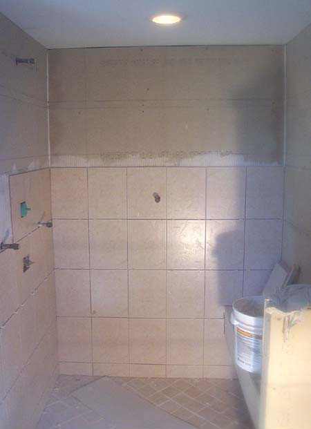 Tile being set - custom shower with seat